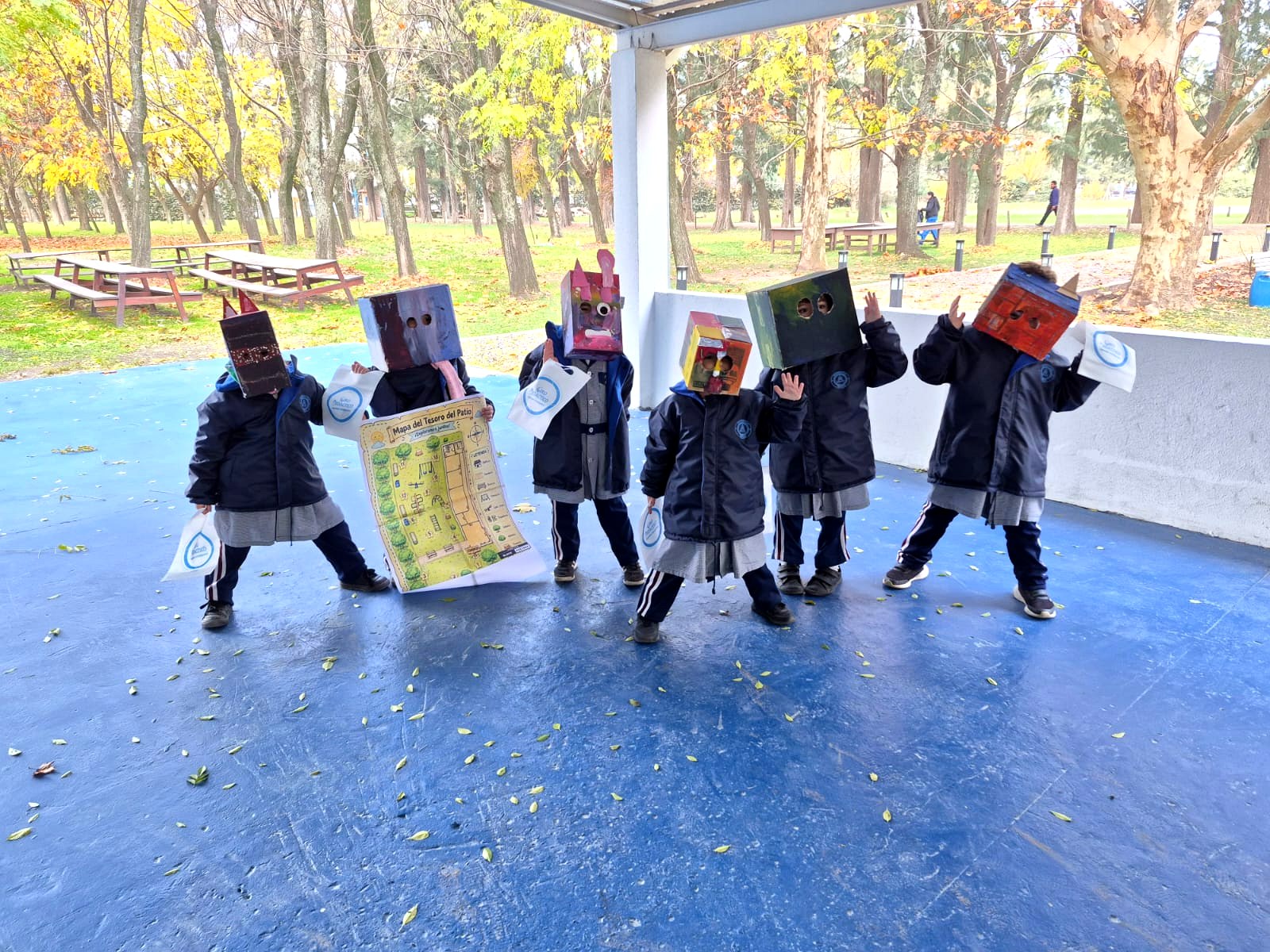 Los chicos disfrazados de robots con sus planos en el parque del colegio